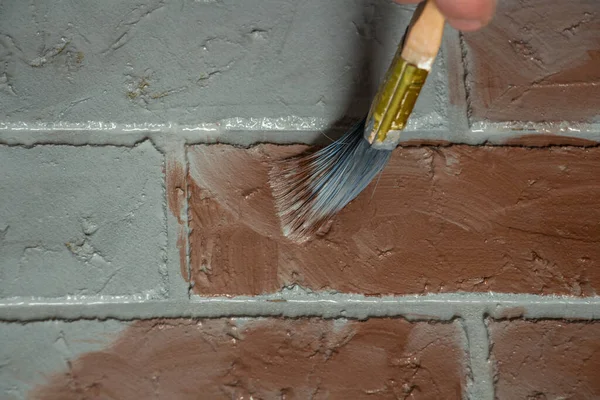 creation of artificial bricks, the process of painting a photographic background with colored paints on a concrete base