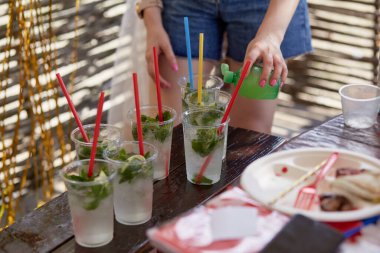 Bekarlığa veda partisinde genç bir kadın şirket için mojito kokteyli hazırlıyor. Hazırlık talimatları. Adım 2. Yüksek kalite fotoğraf