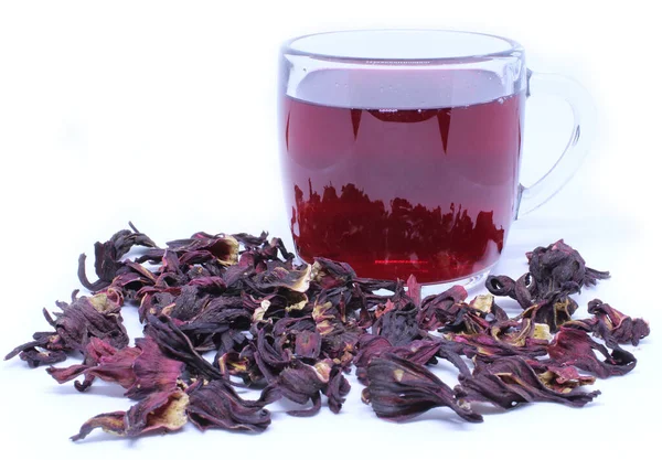 Cup of dry hibiscus tea and petals