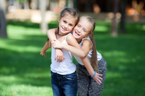 Maravilhosas meninas felizes de pé no gramado . — Fotografia de Stock