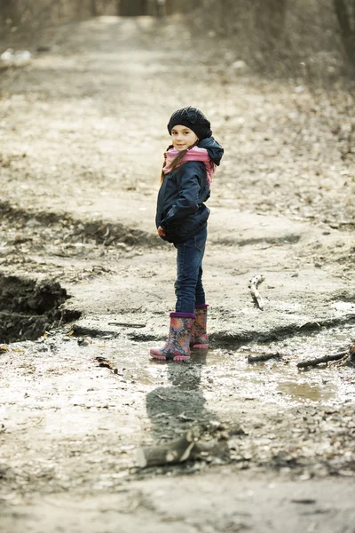 Young girl in rubber boots in the autumn forest — Stock Photo, Image