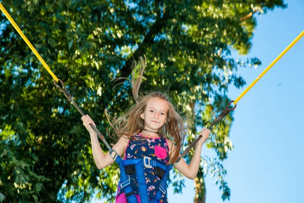 Girl jumping on a trampoline — Stock Photo, Image