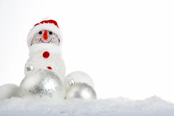 Snowman in the snow with Christmas balls — Stock Photo, Image