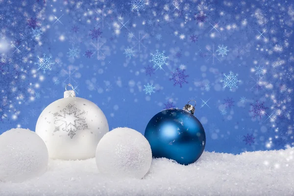 Blue Christmas balls in the snow Royalty Free Stock Images