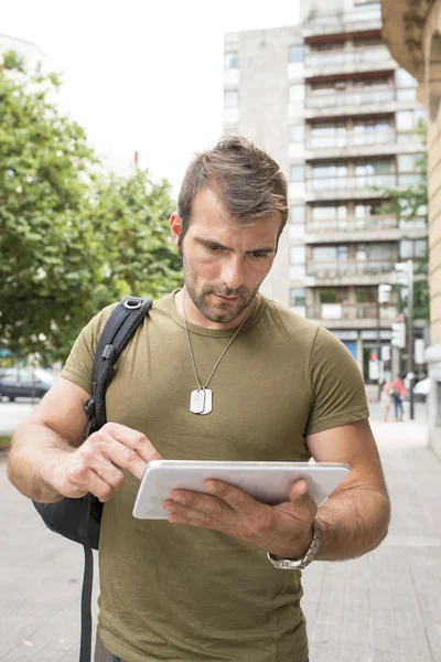 Urban serious man laptop tablet computer in the street, new technology concept. — Stock Photo, Image