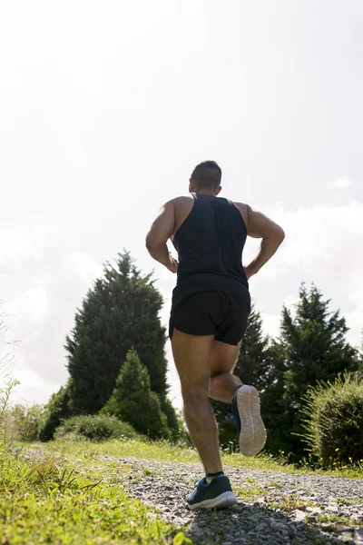 Mann läuft an einem sonnigen Tag die Straße entlang. — Stockfoto