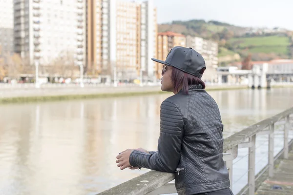 Frau denkt nach und übersieht die Rückansicht der Stadt. — Stockfoto