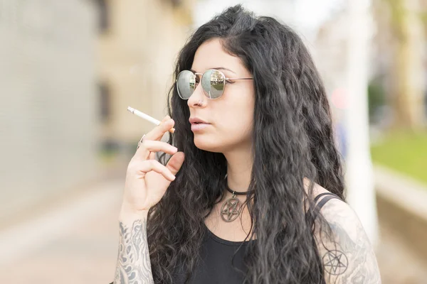 Sensual beautiful tattooed woman smoking. Stock Photo