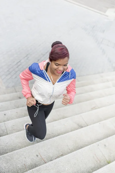Frau macht Sport, joggt Treppen rauf und runter. — Stockfoto