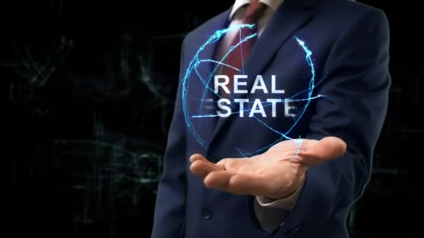 Geschäftsmann zeigt Konzept-Hologramm Immobilien — Stockvideo