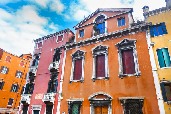 A low angle view of a typical colorful residential building in Venice, Italy.