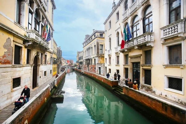 People walking in sidewalks of water canal — Stock Photo, Image