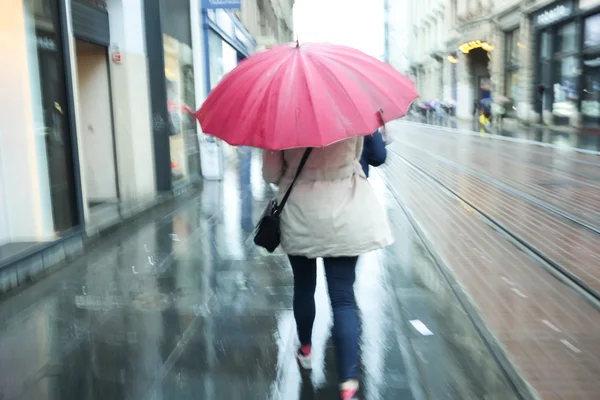 Motion of woman with pink ubrella — Stock Photo, Image