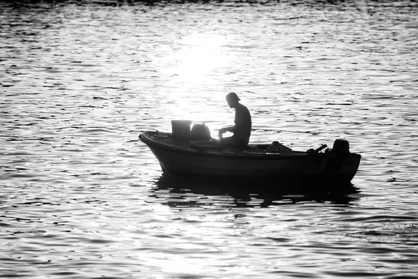 Hombre en barco a motor al atardecer bw — Foto de Stock