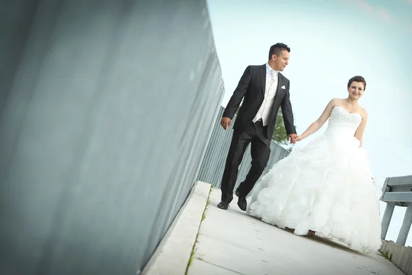 Bride and groom walking in city — Stock Photo, Image