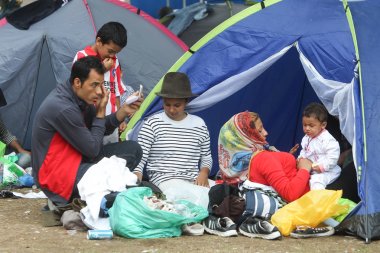 Syrian refugees resting in tent clipart