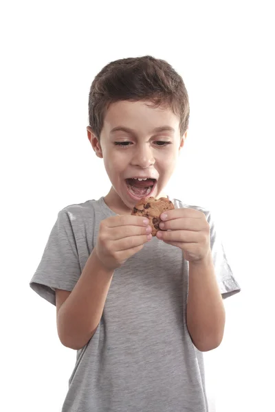 Little boy eating chocolate chip cookie — Stock Photo, Image