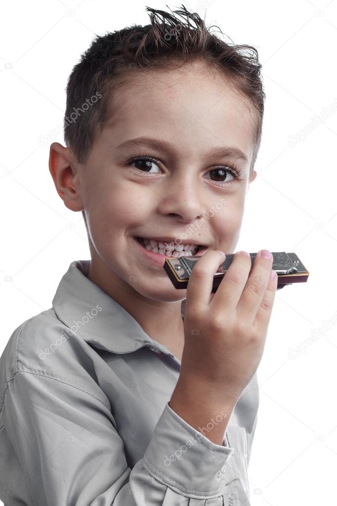 Child playing harmonica Stock Photo by ©kleberpicui 84319414