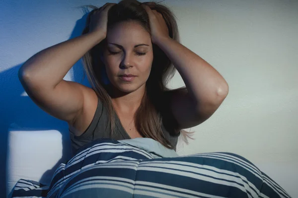 Sleep disorder, insomnia. young blond woman sitting on the bed a — Stock Photo, Image