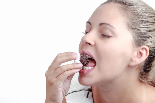 Brazilian beautiful woman eating a brigadeiro — Stock Photo, Image