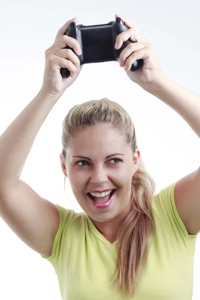 Feliz joven mujer jugando videojuego con joystick inalámbrico —  Fotos de Stock