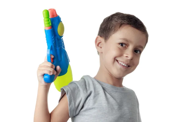 Küçük çocuk üzerinde beyaz izole plastik su tabancası ile oynarken.