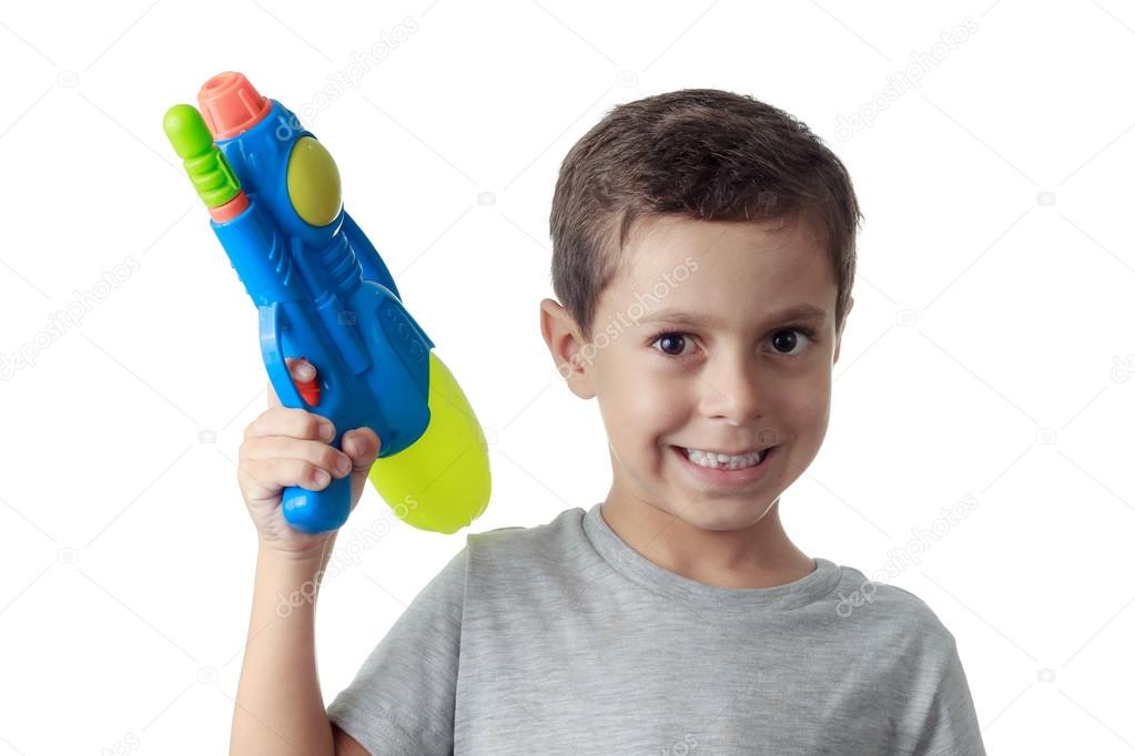 Little boy playing with plastic water gun isolated on white.