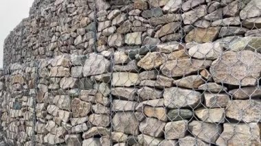 Çelik tel örgü sepetinden yapılmış Gabion duvarı. Taş duvarlar, kıyı aşınmasından korunma. Gabion ve Rock zırh - sahil ve su yolları koruması