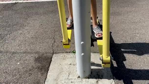 Girl Performs Exercises Leg Trainer Running Walking Stepper Legs Close — Stock Video