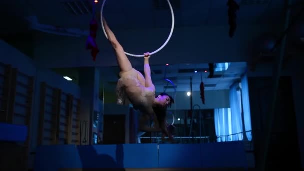 Aerial acrobat woman on circus stage. tricks hoop on a blue background — Stock Video