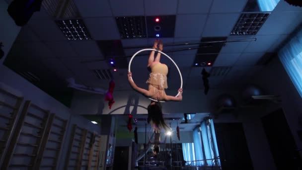 Повітряна акробатна жінка на цирковій сцені. трюки обруч на синьому фоні — стокове відео