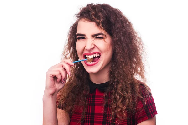 Curly Girl with lollipop in red dress — Stock Photo, Image