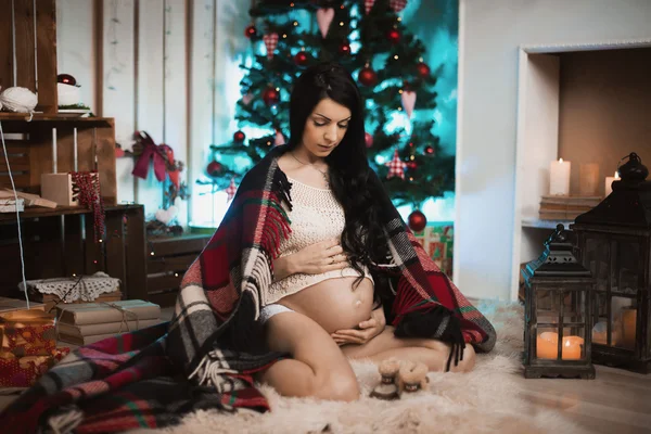 Linda mujer embarazada suave en hermoso árbol de Navidad decorado en casa —  Fotos de Stock