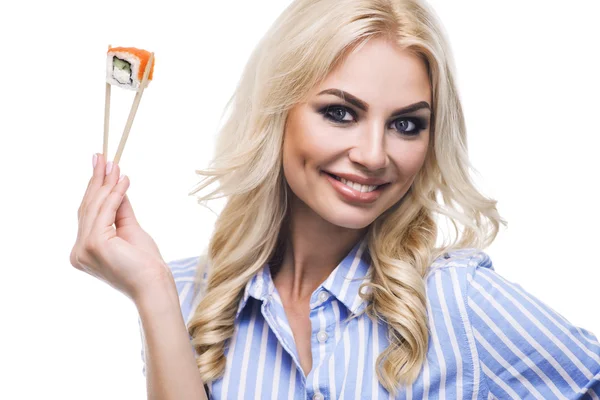 Young woman holding sushi with a chopsticks, isolated on white — Stock Photo, Image