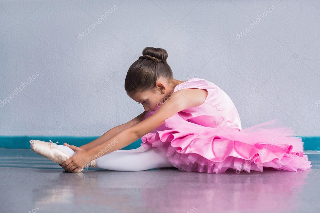 Young ballerina in a pink ballet tutu training in dance class Stock