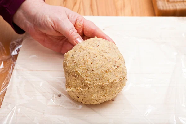 Ready shaped dough ball on plastic wrap — Stock Photo, Image