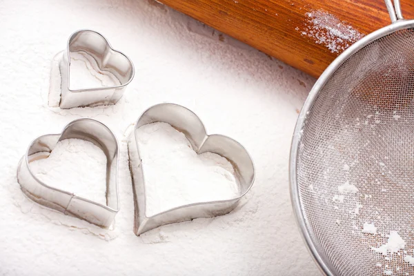 Cookie cutters and flour sieve — Stock Photo, Image