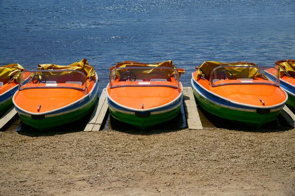 Pedal boats side by side on the shores — Stock Photo, Image