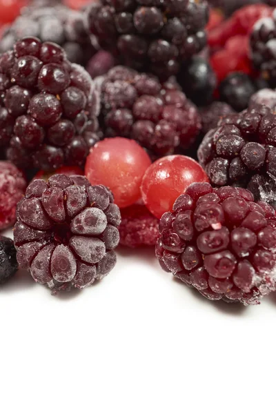 Mixed frozen berry fruits on white — Stockfoto