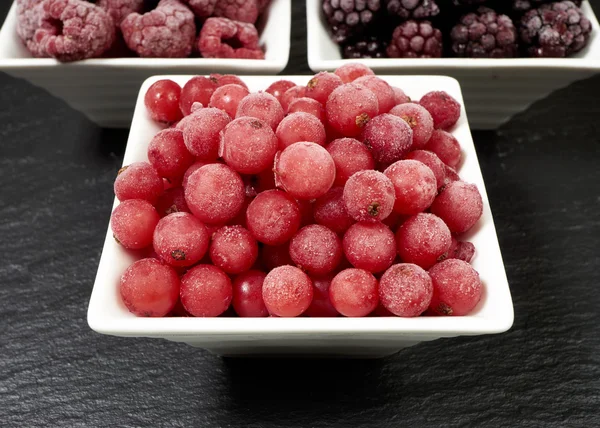 Bowls with three kinds of frozen berries — ストック写真