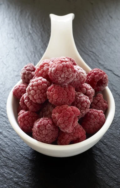 Frozen raspberries in a porcelain dish