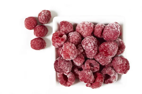 Frozen raspberries in a white porcelain dish — Stock Photo, Image