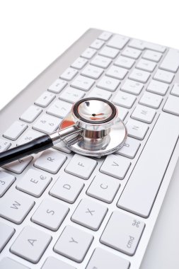 Stethoscope head on computer keyboard