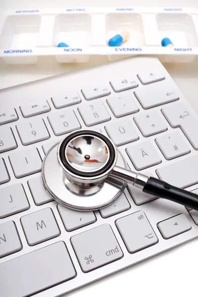 Stethoscope, pill box and keyboard — Stock Photo, Image