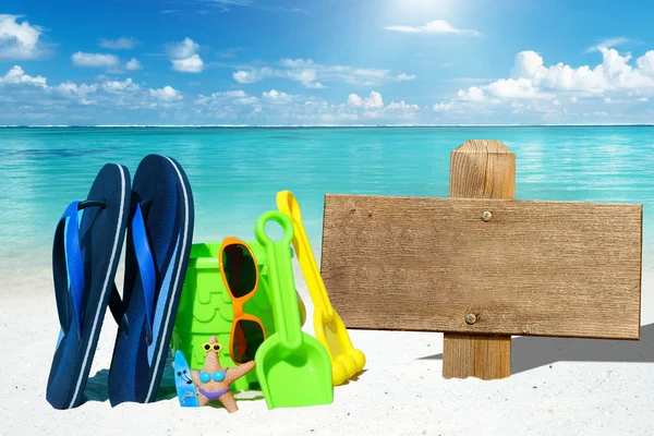 Wooden signboard and beach toys — Stock Photo, Image