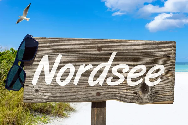 Wooden signboard on the beach — Stock Photo, Image