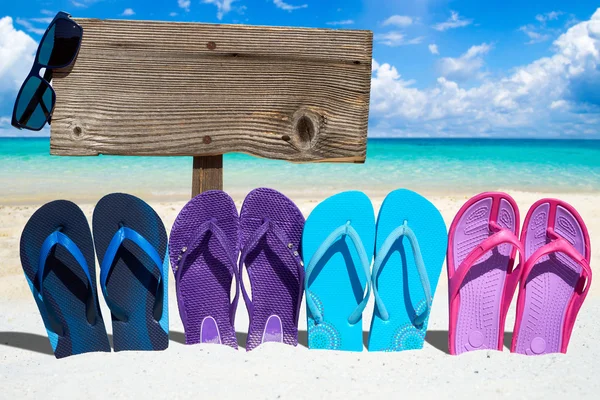 Wooden signboard and flip flops — Stock Photo, Image