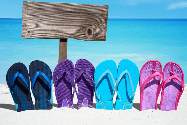 Wooden signboard and flip flops — Stock Photo, Image