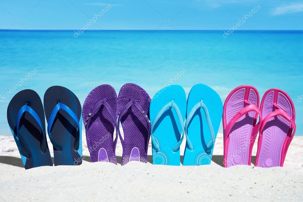 Some colorful  flip flops in a row