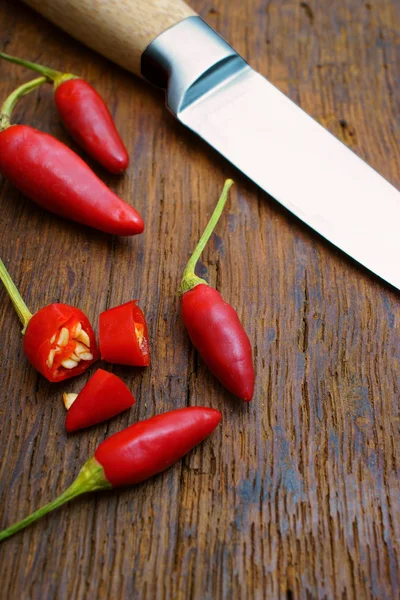 Red Chili Peppers and a Knife — Stock Photo, Image
